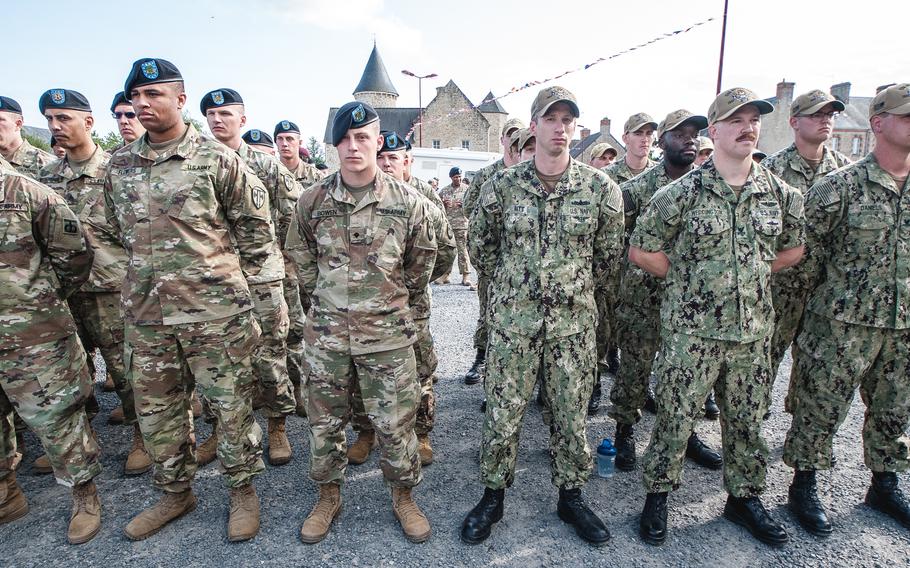 Soldiers and sailors stand in formation during a memorial ceremony at the U.S. Air Force monument in Picauville, France, on June 3, 2019.