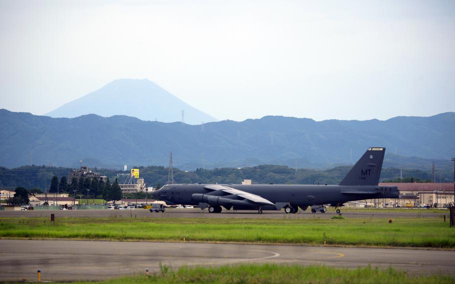 A B-52H Stratofortress bomber parks at Yokota Air Base, Japan, with Mount Fuji in the background, Thursday, July 13, 2023.