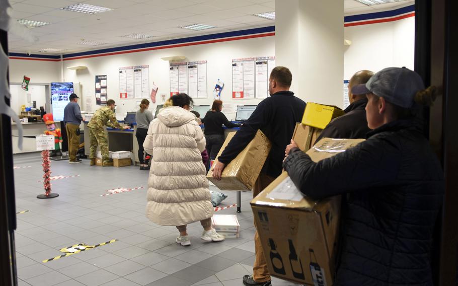 Customers wait in line to fill out electronic customs forms at the Northside Post Office on Ramstein Air Base, Germany, on Monday, Dec. 5, 2022. Military officials say vague or outdated customs forms on parcels being mailed from the United States are reasons a higher than usual number of parcels are being returned to sender this holiday season.