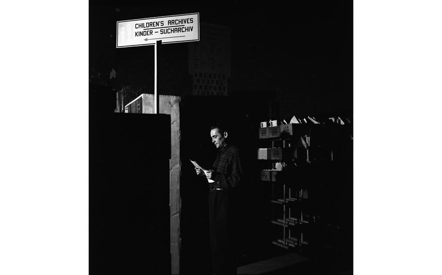 An investigator searches in the Children’s Archives of the International Tracing Service. 