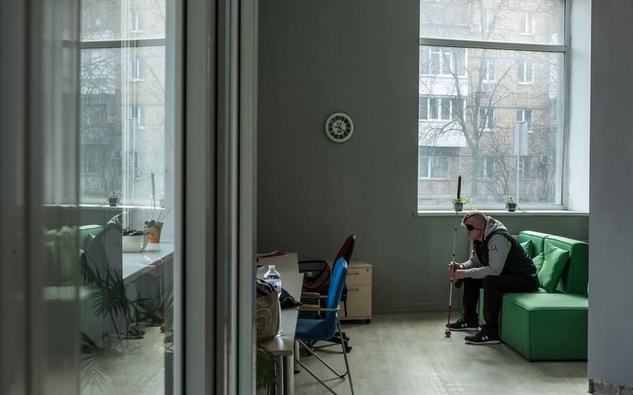 Ruslan Kozachok, 47, a former tattoo artist and a veteran who was blinded by shrapnel on the front line, sits in the Kyiv office of Port, an organization that helps blind veterans and their families adapt after combat.