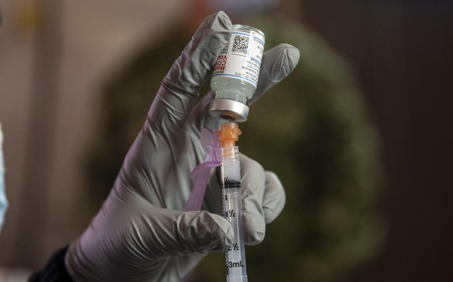 A medical worker fills a syringe with the Moderna COVID-19 vaccine early this year at Camp Foster, Okinawa.