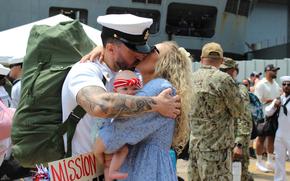 A sailor embraces a loved one