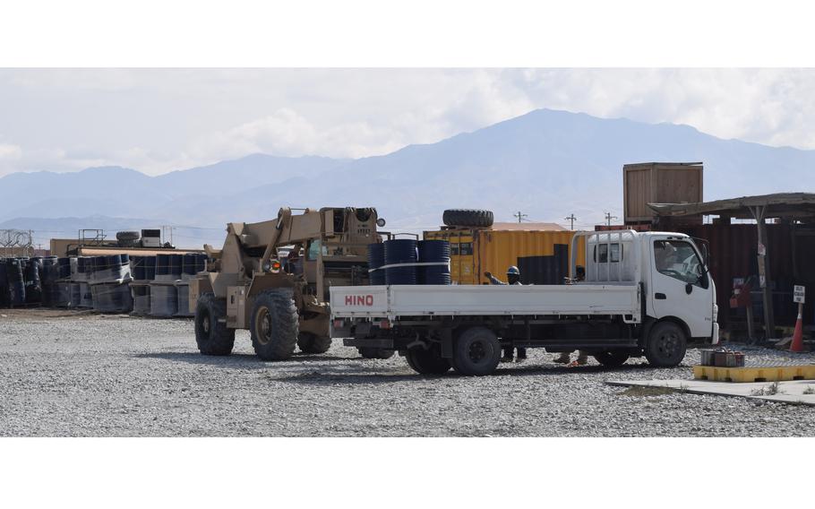 Drums of used fuel are transported to the hazardous materials yard operated by contractor Fluor at Bagram Airfield, Afghanistan, in 2014. A federal judge is allowing a lawsuit again Fluor stemming from a 2016 suicide bomber attack at Bagram to proceed, according to court documents.