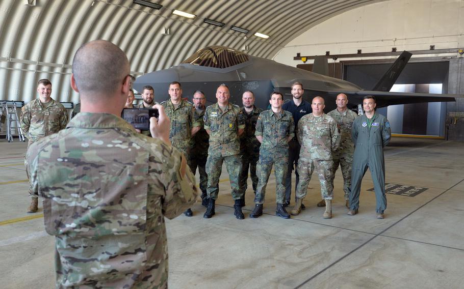 American and German service members have their photo taken June 14, 2023, in front of an F-35 Lightning II in a hangar at Spangdahlem Air Base, Germany. Germany is set to buy F-35s, so a number of maintainers checked out the aircraft during the Air Defender 23 exercise.