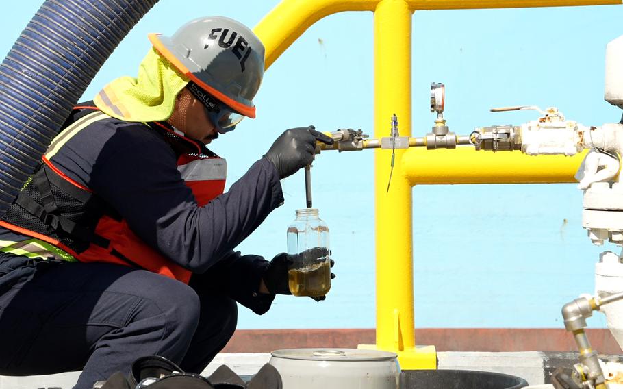 A service member supporting Joint Task Force-Red Hill inspects fuel from the Red Hill Bulk Fuel Storage Facility at Joint Base Pearl Harbor-Hickam, Hawaii, Dec. 7, 2023.