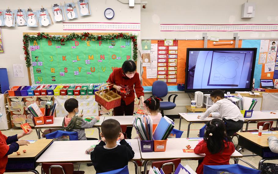 Principal Alice Hom hands out red envelopes and candy in a cultural celebration of the Lunar New Year at Yung Wing School P.S. 124 on Feb. 2, 2022, in New York City.