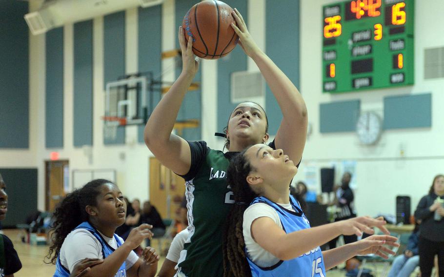 Daegu's Jazmine Harvey shoots over Osan's Zephaniah Martin and Alana San Nicolas during Saturday's Korea girls basketball game. The Warriors won 52-32.