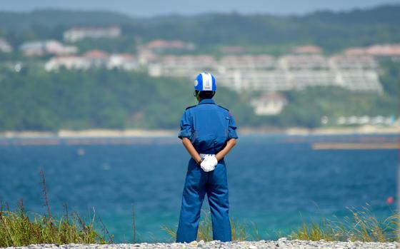 A worker looks out at Oura Bay near Camp Schwab, Okinawa, in September 2022. 