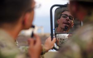 U.S. Army Soldiers with the East Africa Response Force, Task Force Associator, Combined Joint Task Force – Horn of Africa, use the mirror of a U.S. Army Humvee for an early morning shave before the start of the Bull Shark 25-1 exercise at Arta, Djibouti, on Nov. 26, 2024. The semiannual exercise brought together U.S., Djiboutian, Spanish, Japanese, and French forces to enhance communication and interoperability among international partners. It simulated complex personnel recovery scenarios across land, sea, and air domains, testing coordination and operational readiness while strengthening regional security and stability. (U.S. Air Force photo by Master Sgt. Jon Alderman)