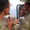 U.S. Army Soldiers with the East Africa Response Force, Task Force Associator, Combined Joint Task Force – Horn of Africa, use the mirror of a U.S. Army Humvee for an early morning shave before the start of the Bull Shark 25-1 exercise at Arta, Djibouti, on Nov. 26, 2024. The semiannual exercise brought together U.S., Djiboutian, Spanish, Japanese, and French forces to enhance communication and interoperability among international partners. It simulated complex personnel recovery scenarios across land, sea, and air domains, testing coordination and operational readiness while strengthening regional security and stability. (U.S. Air Force photo by Master Sgt. Jon Alderman)