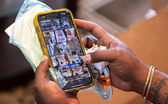 A person’s hands hold an iPhone in a yellow case.