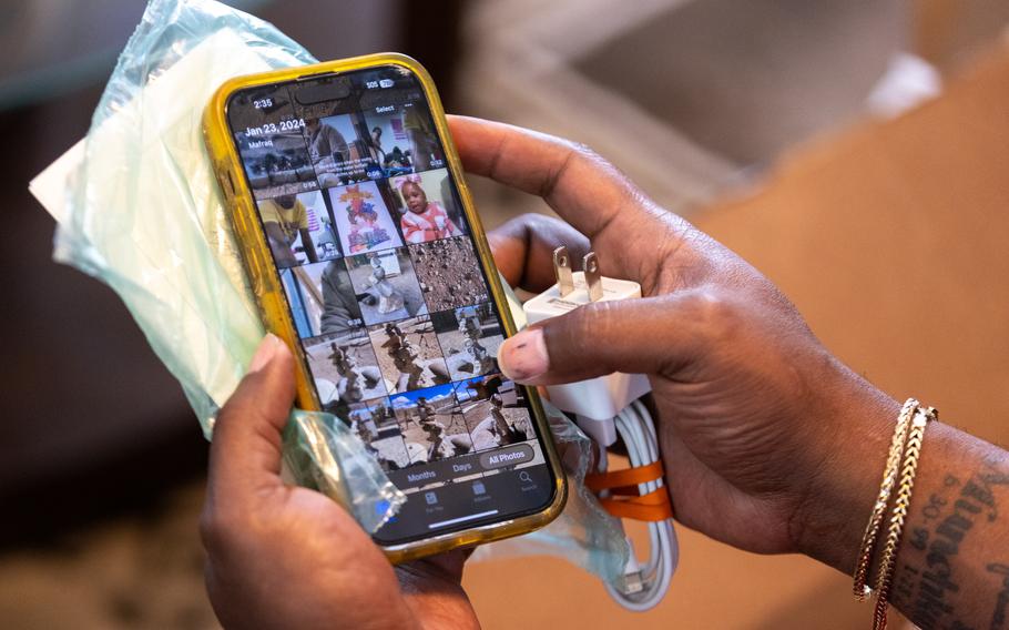 A person’s hands hold an iPhone in a yellow case.