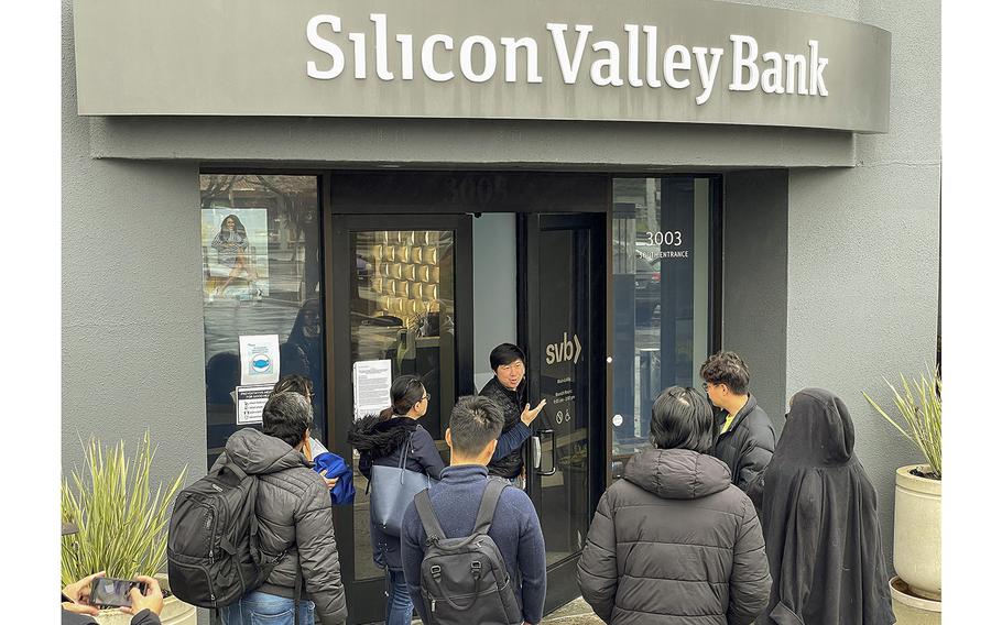 A Silicon Valley Bank employee on Friday, March 10, 2023, tells customers that the headquarters office in Santa Clara, California., was closed. Silicon Valley Bank was shut down on Friday morning by California regulators and was put in control of the U.S. Federal Deposit Insurance Corp. 