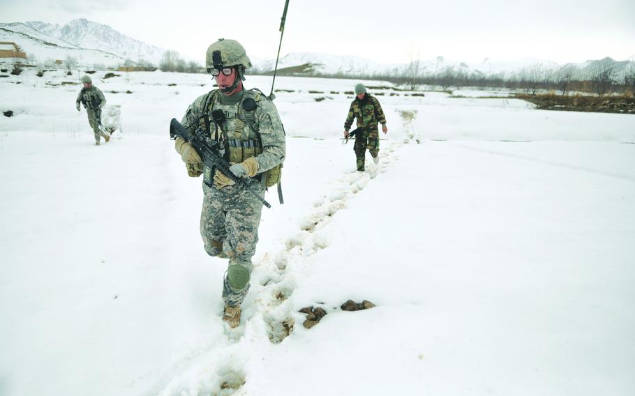 U.S. Army Spc. David Robertson, Company B, 173rd Airborne Brigade Combat Team, trudges through the snow on a recent air assault mission in Wardak province.