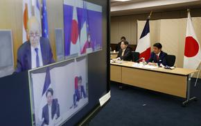 Japan's Foreign Minister Yoshimasa Hayashi, centre and Defense Minister Nobuo Kishi,participate in a video conference with France's Foreign Minister Jean-Yves Le Drian and Defence Minister Florence Parly, at the Foreign Ministry in Tokyo, Japan, Thursday, Jan. 20, 2022. Foreign and defense ministers from Japan and France held their virtual talks Thursday as the two countries seek to deepen their security ties in the Indo-Pacific where tension rises amid China’s military buildup and North Korea’s missile advancement. (Issei Kato/Pool via AP)