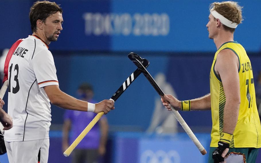 Germany's Tobias Constantin Hauke, left, and Australia's Aran Zalewski (17) greet each other before a men's field hockey semi-final match at the 2020 Summer Olympics Aug. 3 in Tokyo, Japan. 