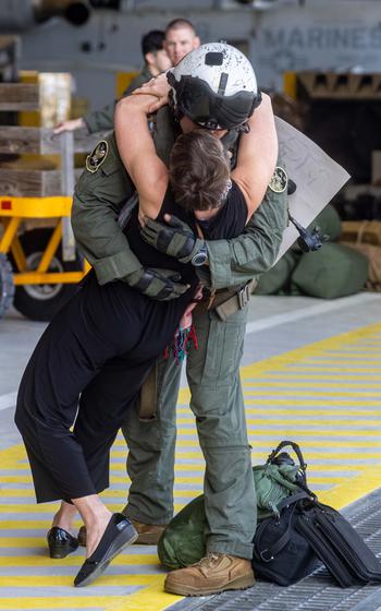 A U.S. Marine kisses his wife after returning from deployment with the 26th Marine Expeditionary Unit (Special Operations Capable), Marine Corps Air Station New River, N.C., Saturday, March 16, 2024.