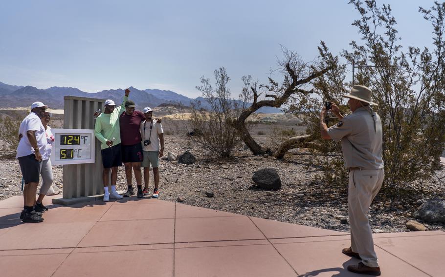 With record-setting heat expected Saturday, tourists such as the Osborne family from Memphis stopped by the thermometer in California's Death Valley National Park. 