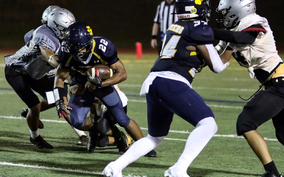 Guam High's DeShawn Baird finds running room with the help  of a block by Panthers teammate Jalen Mann.