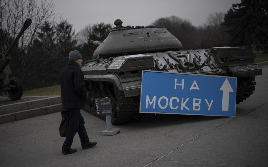 A man walks by a sign that reads “to Moscow” placed on an old tank displayed at a war museum in Kyiv, Ukraine, Wednesday, Jan. 25, 2023.