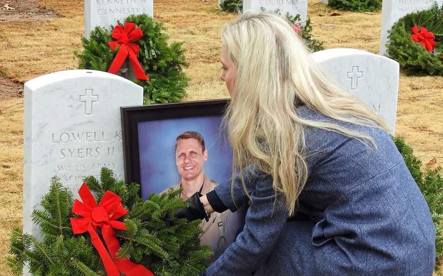 Tonya Syers in 2019 at the gravesite of her husband, Army veteran Lowell Syers, at Georgia National Cemetery near Canton in northwestern Georgia.