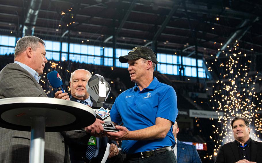 Air Force head coach Troy Calhoun is handed the Commander’s Class trophy after Air Force defeated Army 13-7 on Nov. 5, 2022, at Globe Life Field in Arlington, Texas. The Falcons claimed the Commander-in-Chief’s Trophy for the 21st time in 2022. 