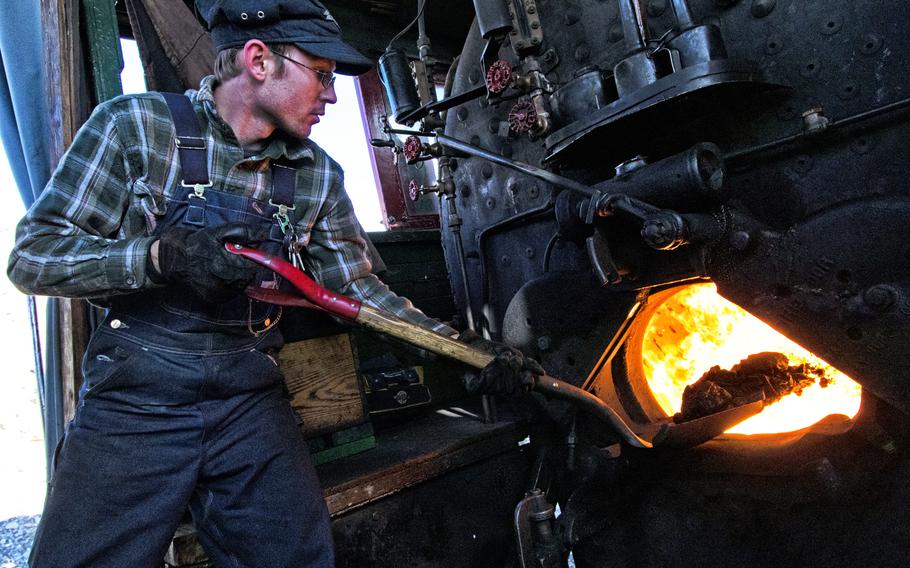 Con Trumbull, the archivist and trainmaster of the Nevada Northern Railway, shovels a load of coal into the firebox of locomotive No. 40. 