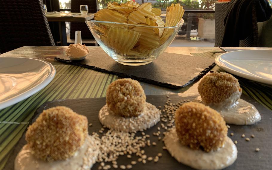 Cavoli Nostri's tapas and starters menu includes arancini, or rice balls, and the restaurant's version of the Spanish patatas bravas.