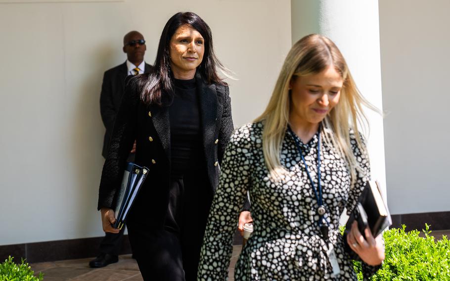 Gabbard walks behind another woman just outside the White House.