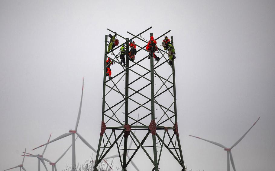 Assembling a high-voltage electricity transmission tower in Germany in April 2022.