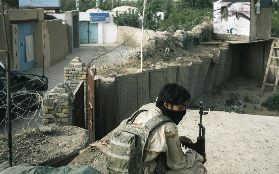 A policeman sits in an outpost in Kandahar, Afghanistan, as Afghan security forces find themselves engaged in a battle with the Taliban inside the city limits. 