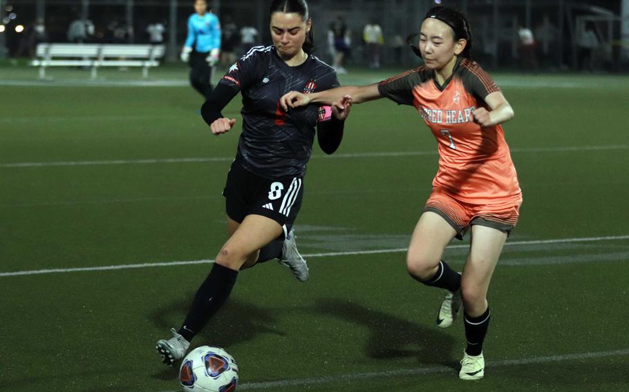 Nile C. Kinnick's Julia Angelinas dribbles upfield against International School of the Sacred Heart during Tuesday's Kanto Plain girls soccer match. The Red Devils won 8-1.