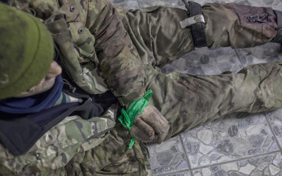 Mikhail, 35, has a tourniquet on his left leg and his hands taped together on Monday, after being captured during fighting north of the city of Bakhmut in eastern Ukraine. He said he was released from prison in Russia after agreeing to fight in Ukraine with the Wagner mercenary group. 