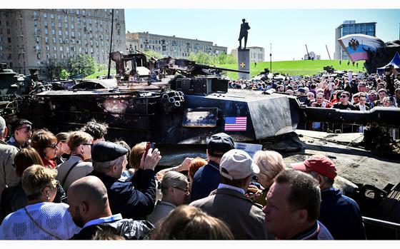 People look at US M12A1 Abrams tank captured by Russian forces in Ukraine, displayed at the WWII memorial complex at Poklonnya Hill western in Moscow, on May 1, 2024. The Russian Ministry of Defence opened an exhibition of samples of "Western weapons and military equipment" captured by Russian forces in Ukraine. The exhibition will last for one month. (Alexander Nemenov/AFP/Getty Images/TNS)