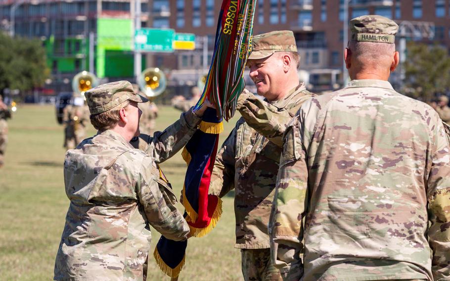 Maj. Gen. Charles Aris, right, accepts the flag of the 36th Infantry Division from Maj. Gen. Tracy Norris, adjutant general of the Texas Military Department, during his assumption of command ceremony in October. Both generals were abruptly replaced from their commands last week and their retirements announced. 