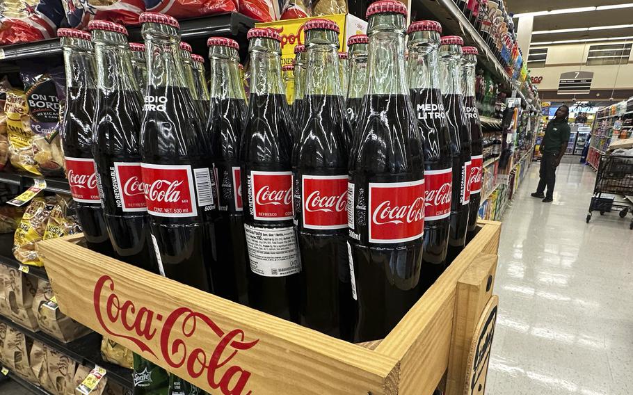 Coca-Cola bottles are seen in a crate.
