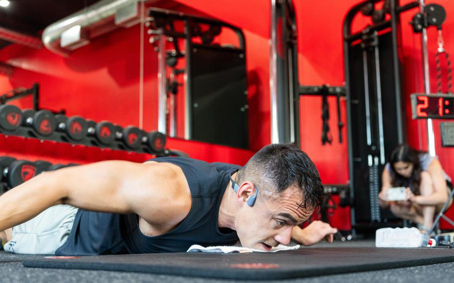 Maj. Tommy Vu performs the hand release portion of a pushup