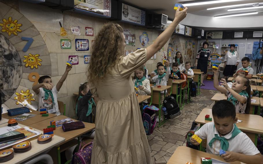 Hanna Neelova, 43, teaches her first grade students in one of the many classrooms that have been built in Kharkiv’s underground metro to protect the students from Russian missiles.
