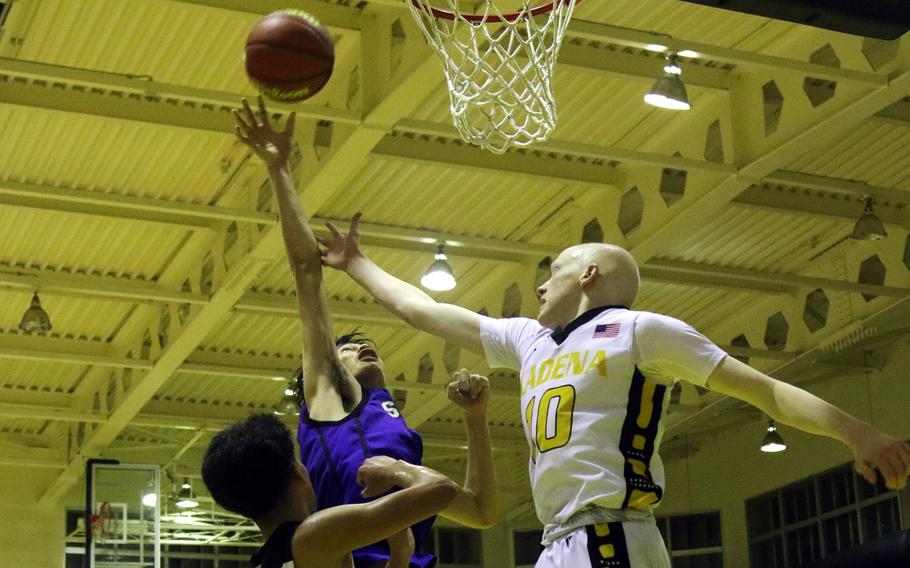 Kadena's Andrew Eaglin and St. Mary's Vincent Willis go up for a rebound in the boys D-I final.