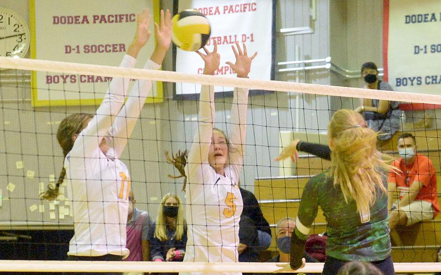 Kubasaki's Emma Leggio drills a spike through the double block of Kadena's Presley Pearce and Morgan Sayers during Thursday's Okinawa volleyball match. The Dragons won in straight sets, improving to 8-0 this season against the Panthers without dropping a set.