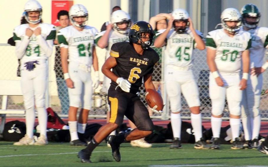 Kadena's Kai Christy looks downfield for open space after intercepting a Kubasaki pass.