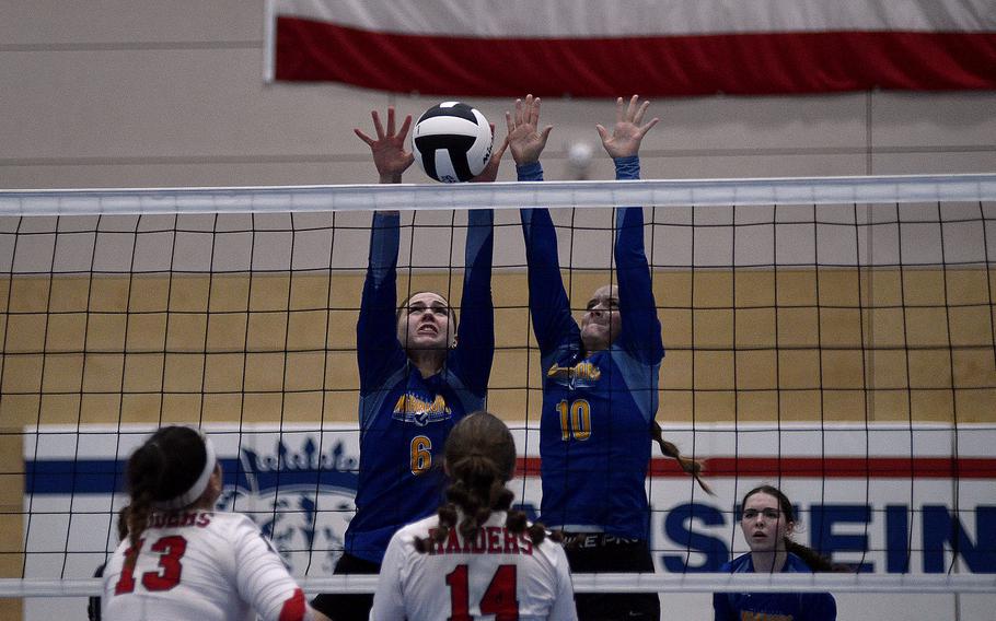 Wiesbaden's Lorelei Kemmer, left, and Rylee Ashcraft block a hit by Kaiserslautern's Mia Hahn during a Division I semifinal at the DODEA European volleyball championships on Oct. 27, 2023, at Ramstein High School on Ramstein Air Base, Germany.