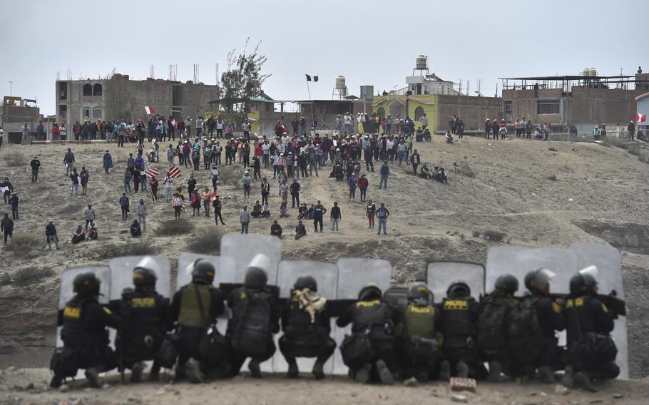 Anti-government protesters face off with security outside Alfredo Rodriguez Ballon airport in Arequipa, Peru, Thursday, Jan. 19, 2023. Protesters are seeking immediate elections, President Dina Boluarte’s resignation, the release of ousted President Pedro Castillo and justice for up to 48 protesters killed in clashes with police. 