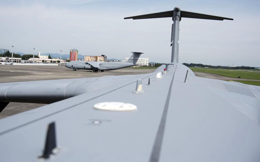 Two C-5M Super Galaxy airlifters park on the flight line at Yokota Air Base, Japan, Sept. 13, 2021. 