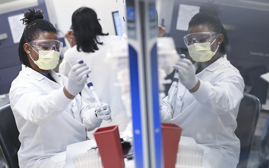 Novavax employees work in the company’s Gaithersburg, Md., lab. 