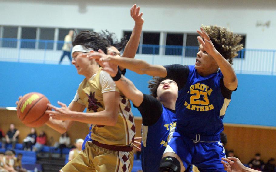 Perry's Sam Kasperski comes down with a rebound in front of Yokota's Braedan Raybon.