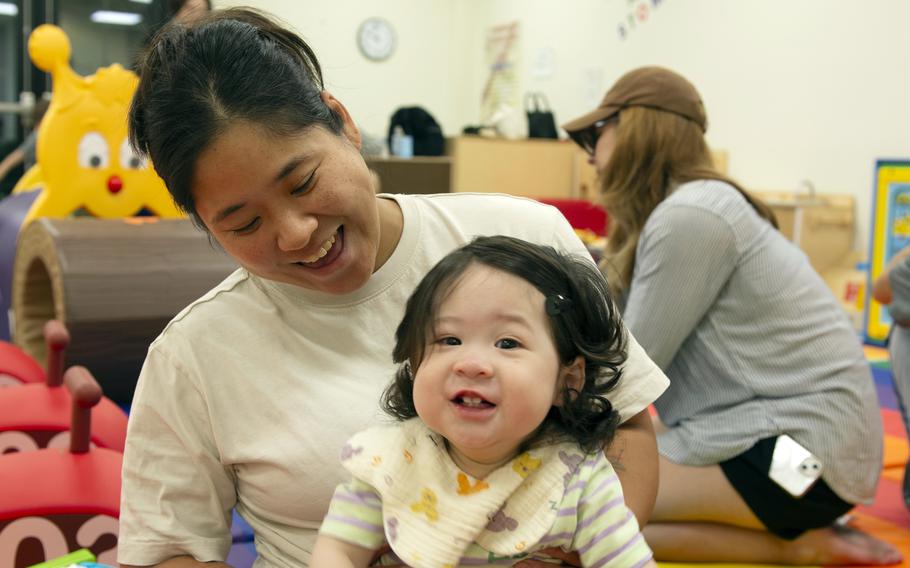 A woman holding her child.