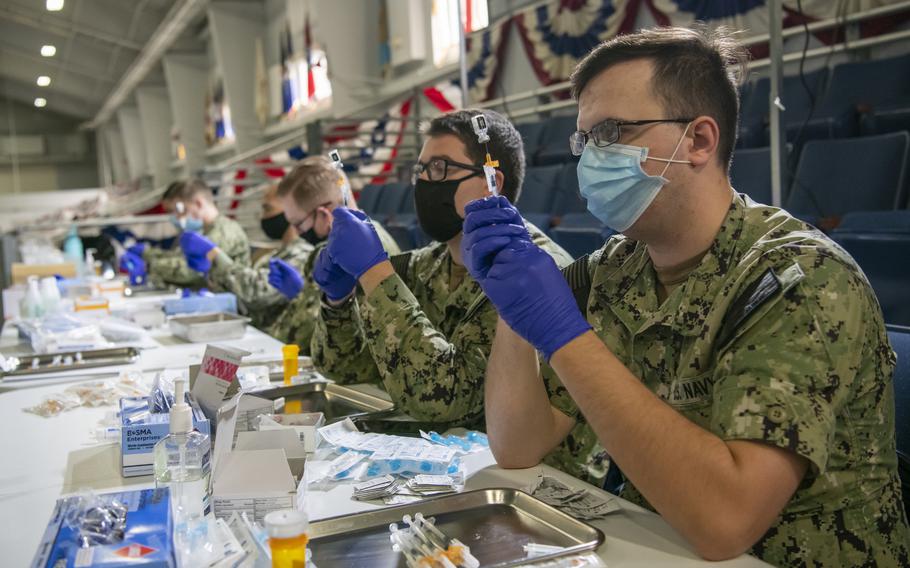 Medical workers at Recruit Training Command in Great Lakes, Ill., prepare doses of COVID-19 vaccine in May 2021. Just over 70% of active-duty U.S. service members were fully vaccinated against COVID-19 as of Sept. 8, 2021.