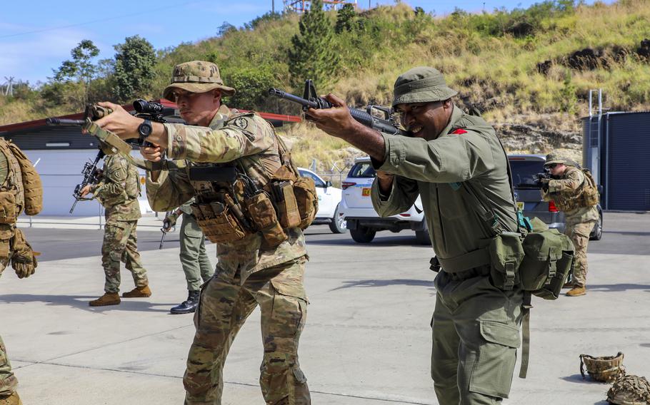 A U.S. Army soldier, left, and a member of the Republic of Fiji military forces look down their rifle sights as part of Exercise Cartwheel at Black Rock Camp, Fiji, September 13, 2022. A military exercise in Fiji involving the United States, Britain, Australia and New Zealand ends this week as the traditional allies counter China’s growing influence in the region.